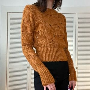 Woman’s Wool and Alpaca blend knit with wholes. Size Small